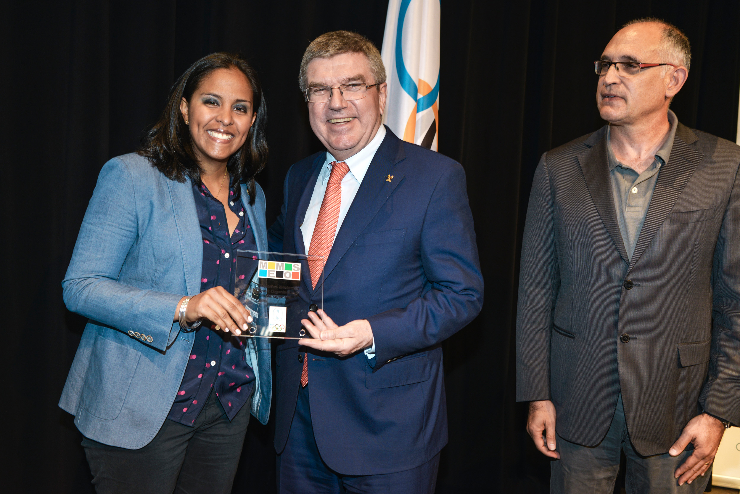 Photo of Damaris Young's graduation ceremony with President Bach and Dr. Andreu Camps 